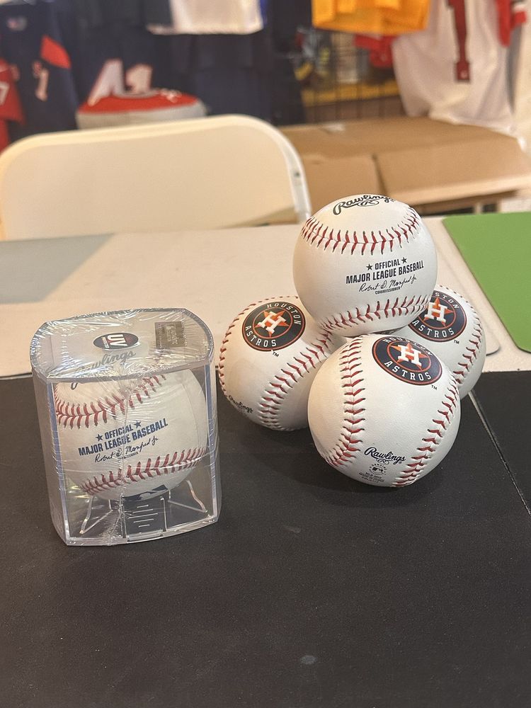 Houston Astros logo baseballs and an official Major League baseball in a display cube