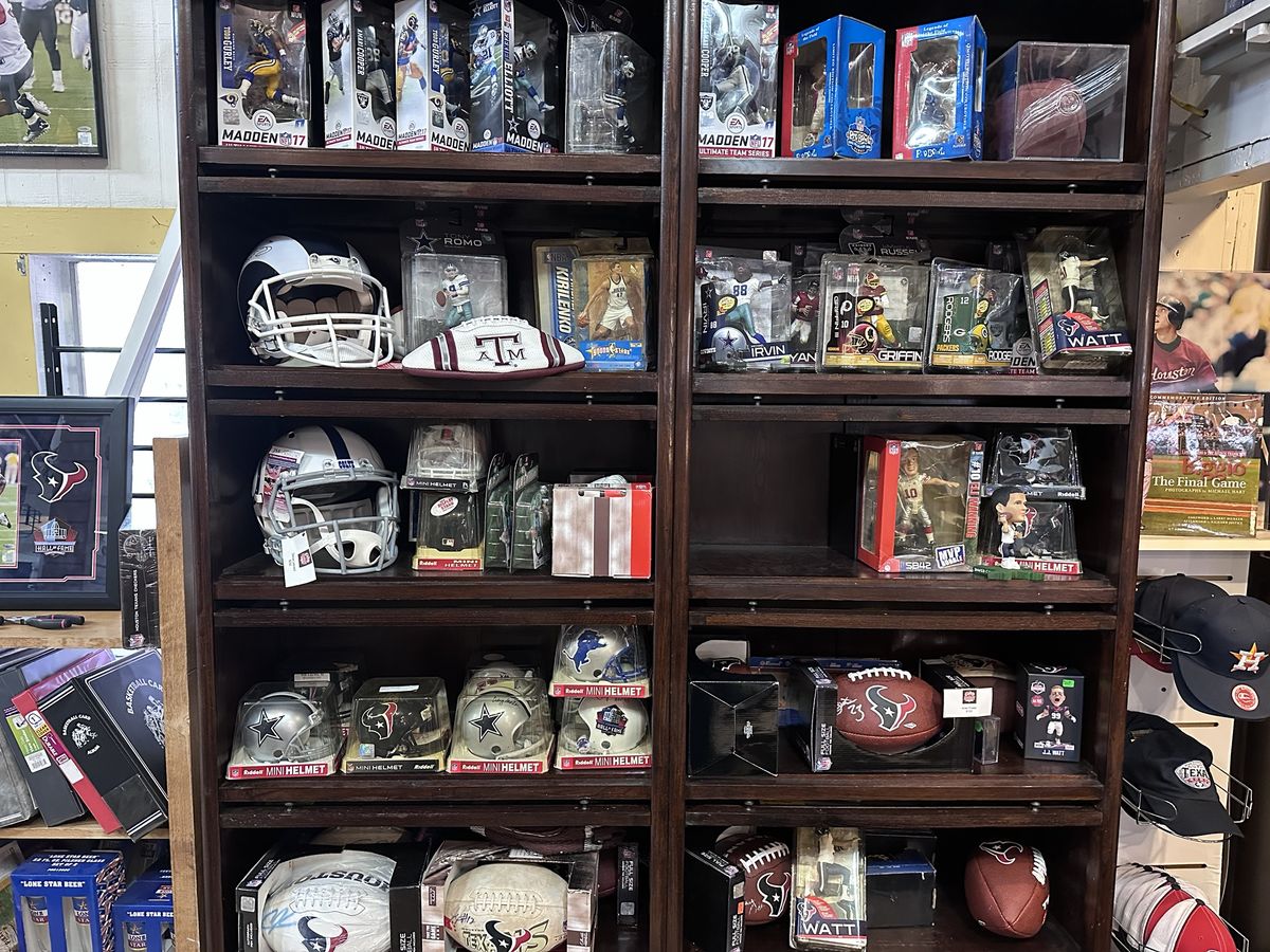 Shelves of football helmets, figures and signed footballs