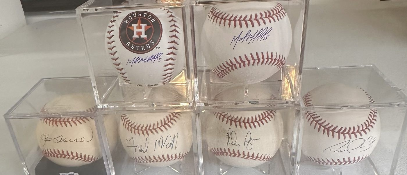 Six signed baseballs in display cubes, including an Astros logo ball