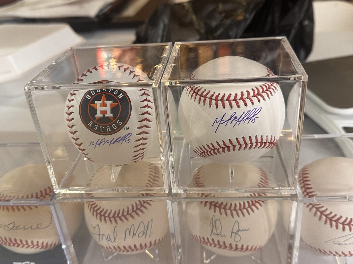 Signed baseballs in display cubes